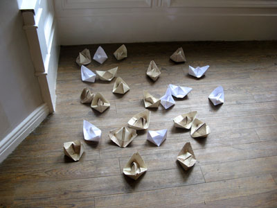 “Life Boat”(2012): origami boats installation; wallpaper, copier paper; dimensions variable